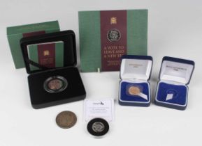 An Elizabeth II sovereign 2000, within a presentation box, and an empty presentation box for a