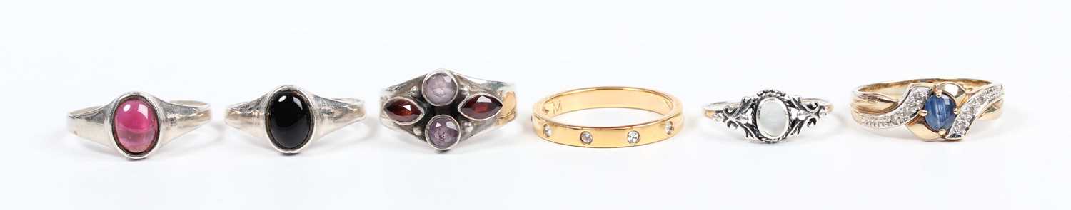 A 9ct gold, sapphire and diamond ring, claw set with the oval cut sapphire between diamond three - Image 2 of 4