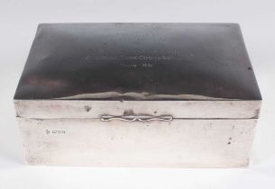 An Edwardian silver rectangular cigarette box, the hinged lid presentation engraved 'Presented to