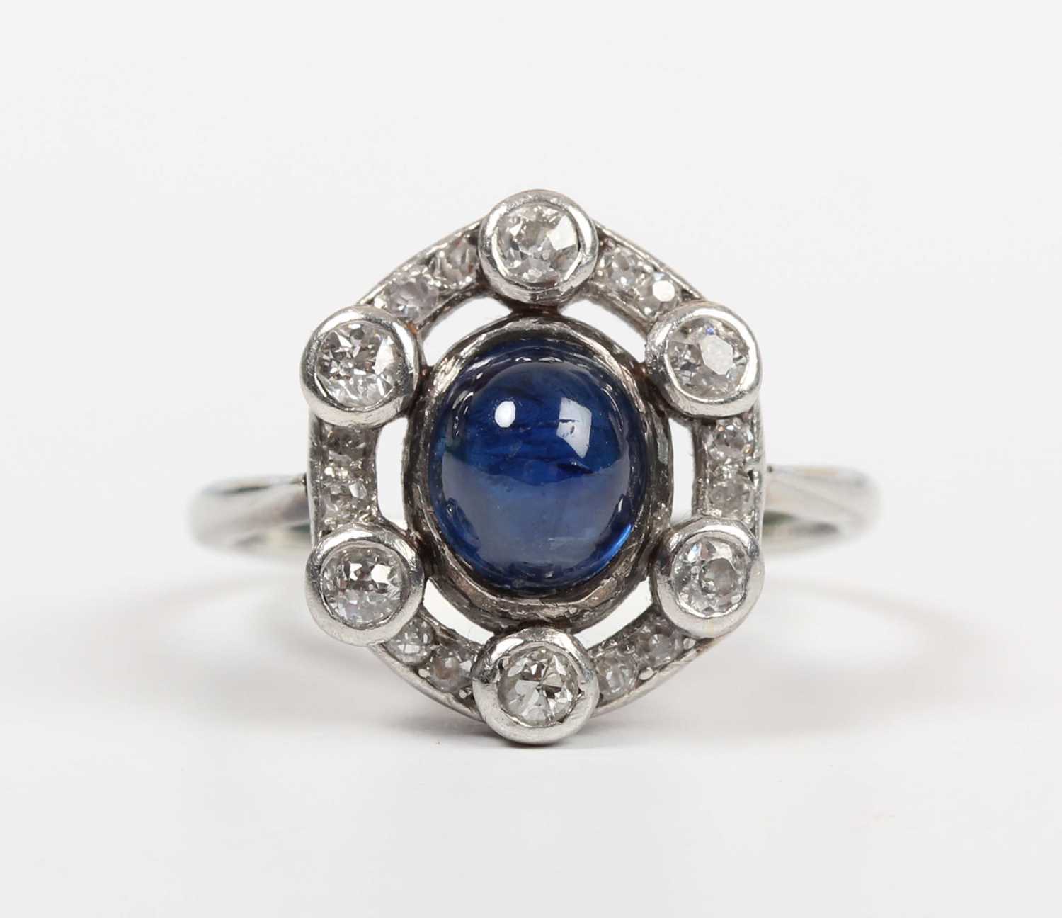 A cabochon sapphire and diamond ring, mounted with the oval cabochon sapphire within an openwork - Image 2 of 5