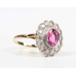 A gold, pink tourmaline and diamond oval cluster ring, collet set with the oval cut pink