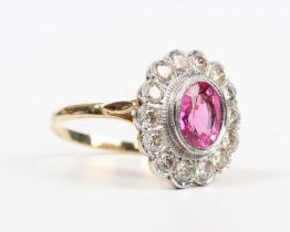 A gold, pink tourmaline and diamond oval cluster ring, collet set with the oval cut pink