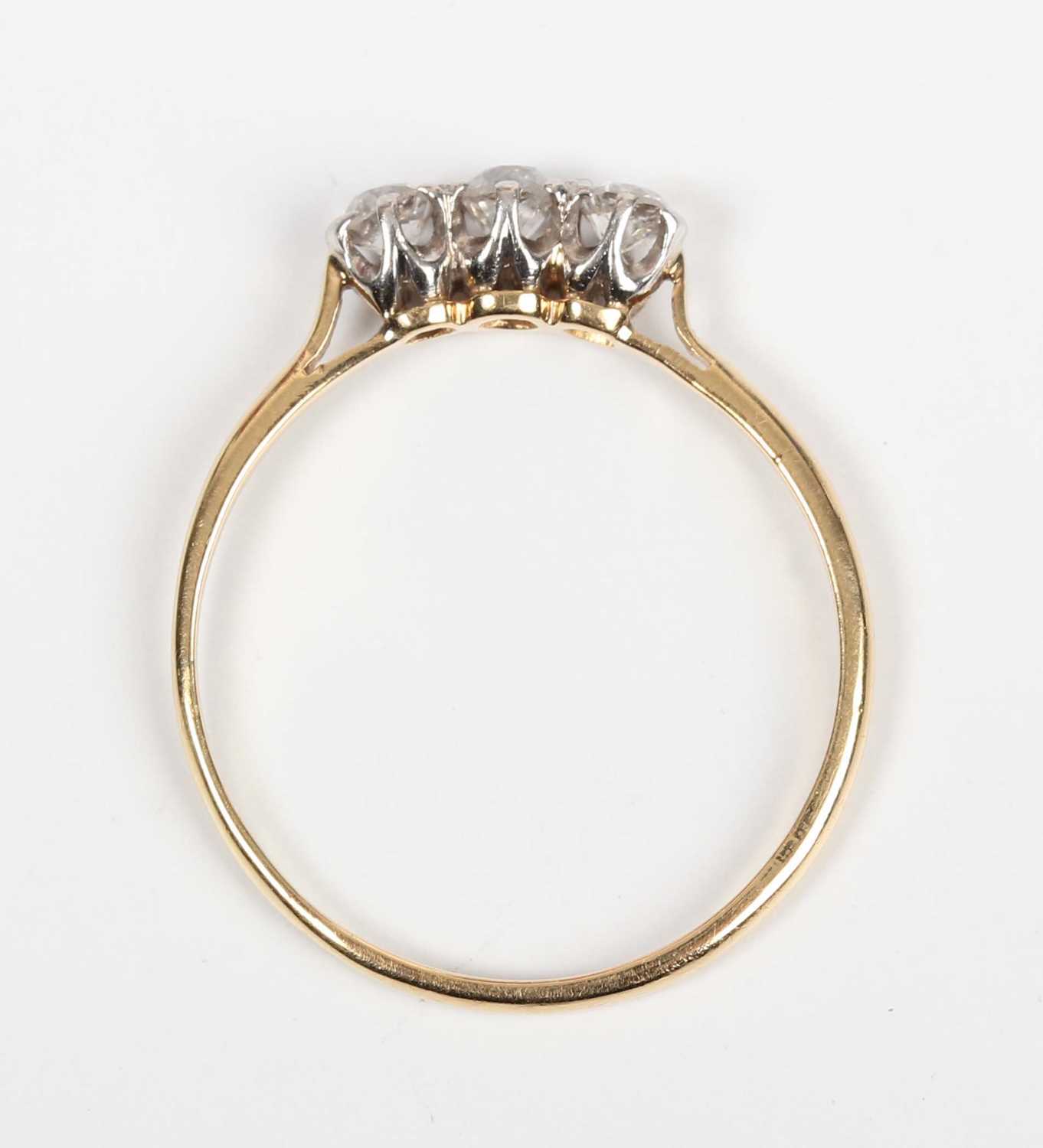 A gold, platinum and diamond three stone ring, claw set with a row of old cut diamonds, detailed ‘ - Image 4 of 5
