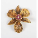 A gold, ruby and colourless gem set brooch, designed as a flowerhead, detailed ‘14’, weight 9.2g,