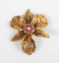 A gold, ruby and colourless gem set brooch, designed as a flowerhead, detailed ‘14’, weight 9.2g,