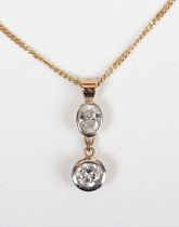 A gold and diamond two stone pendant, collet set with a circular cut diamond below an oval cut