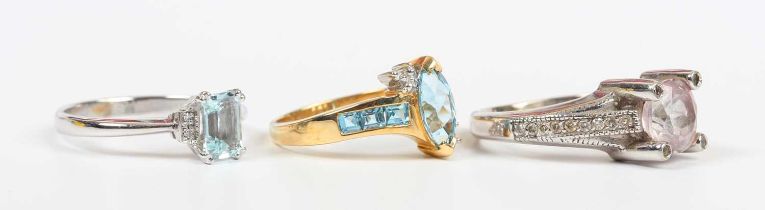 An aquamarine and diamond ring, claw set with the cut cornered rectangular step cut aquamarine