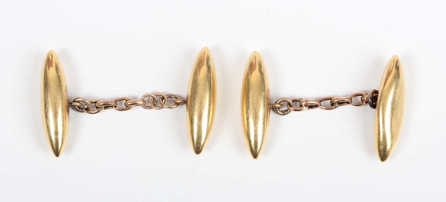 A pair of gold torpedo shaped cufflinks, detailed ‘18c’, with associated connecting chains, total