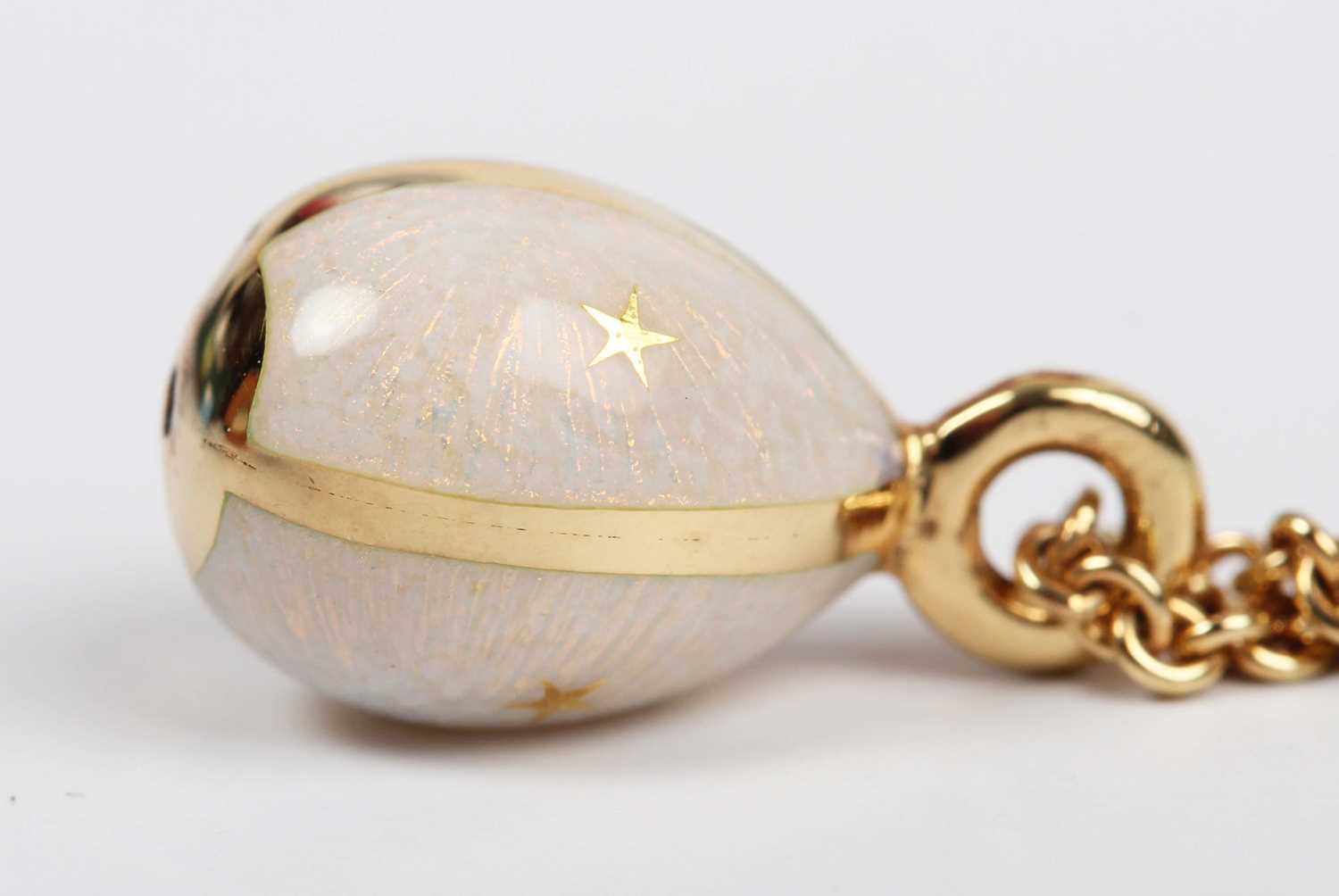 A modern Fabergé gold and semitranslucent pink enamelled egg pendant, decorated with gold stars, - Image 4 of 6