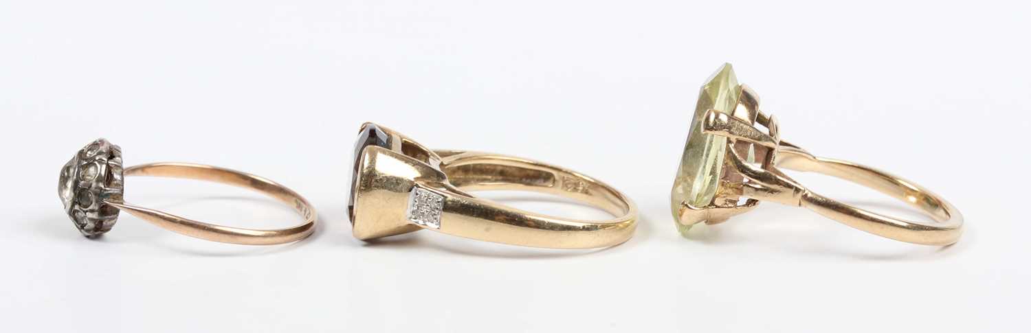 A gold, smoky quartz and diamond ring, mounted with an oval cut smoky quartz between diamond four - Image 3 of 4