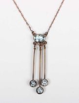 A gold and aquamarine pendant necklace, circa 1910, collet set with the principal oval cut