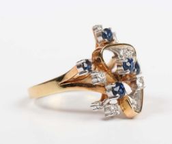 A gold, sapphire and diamond ring in an abstract design, claw set with five circular cut