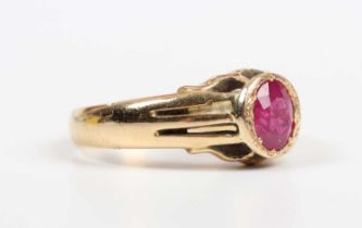 A gold ring, mounted with an oval cut treated ruby, detailed ‘18ct’, weight 6.4g, ruby weight approx