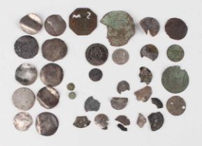 A collection of various metal detector-found coins, including Roman and hammered (most in ground-