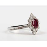 A ruby and diamond cluster ring, claw set with the oval cut ruby within a marquise shaped surround