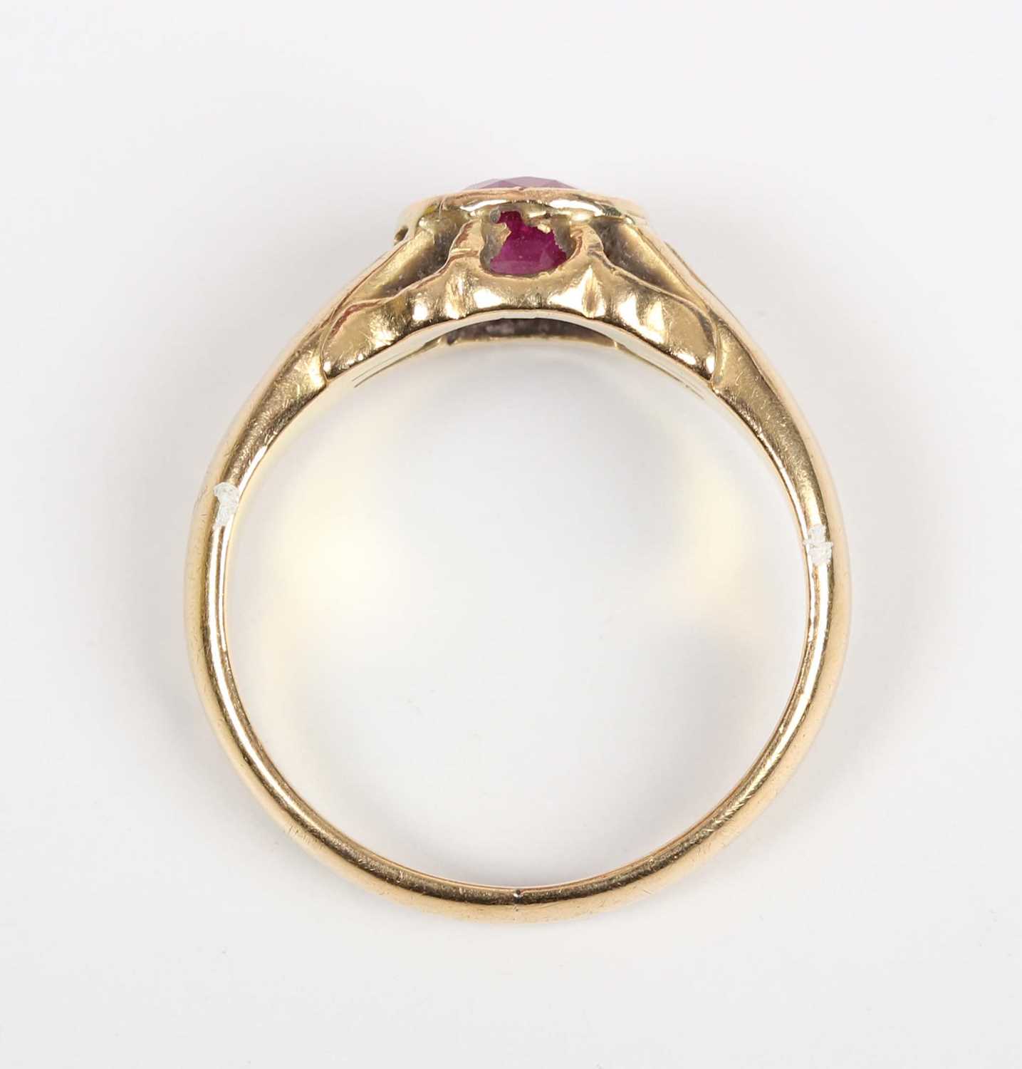 A gold ring, mounted with an oval cut treated ruby, detailed ‘18ct’, weight 6.4g, ruby weight approx - Image 4 of 5
