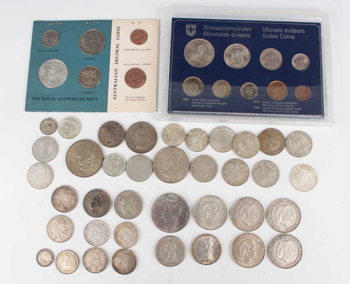 A small collection of various European and world silver and metal coinage, including a Switzerland