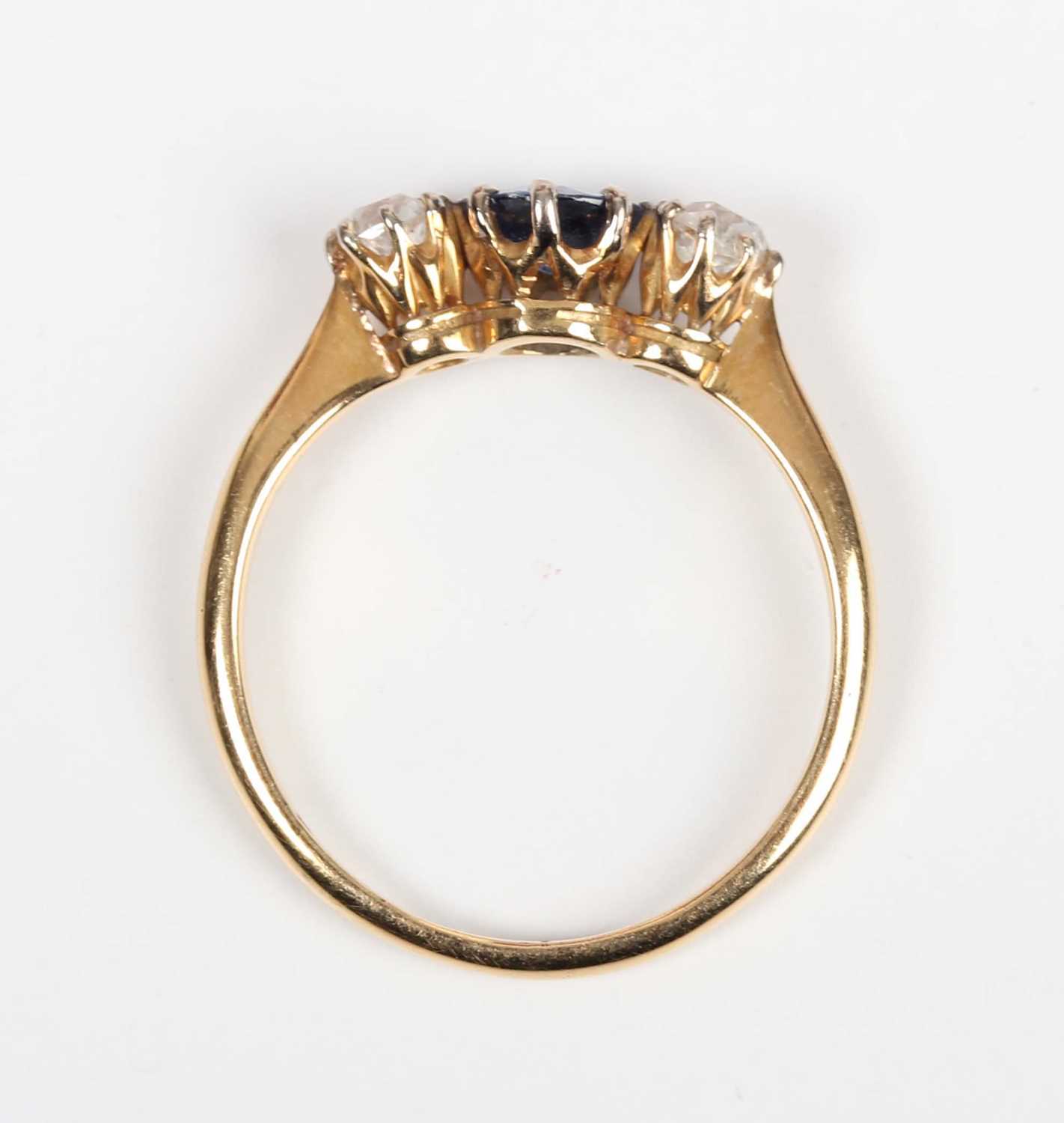 A gold, platinum, sapphire and diamond ring, claw set with a circular cut sapphire between two old - Image 4 of 5