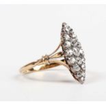 A gold and diamond marquise shaped ring, mounted with old cut diamonds between split shoulders,