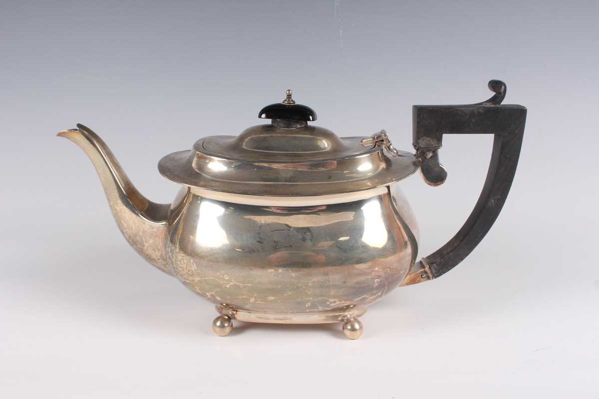 A George V silver cushion shaped teapot on ball feet, Birmingham 1926 by Henry Matthews, weight