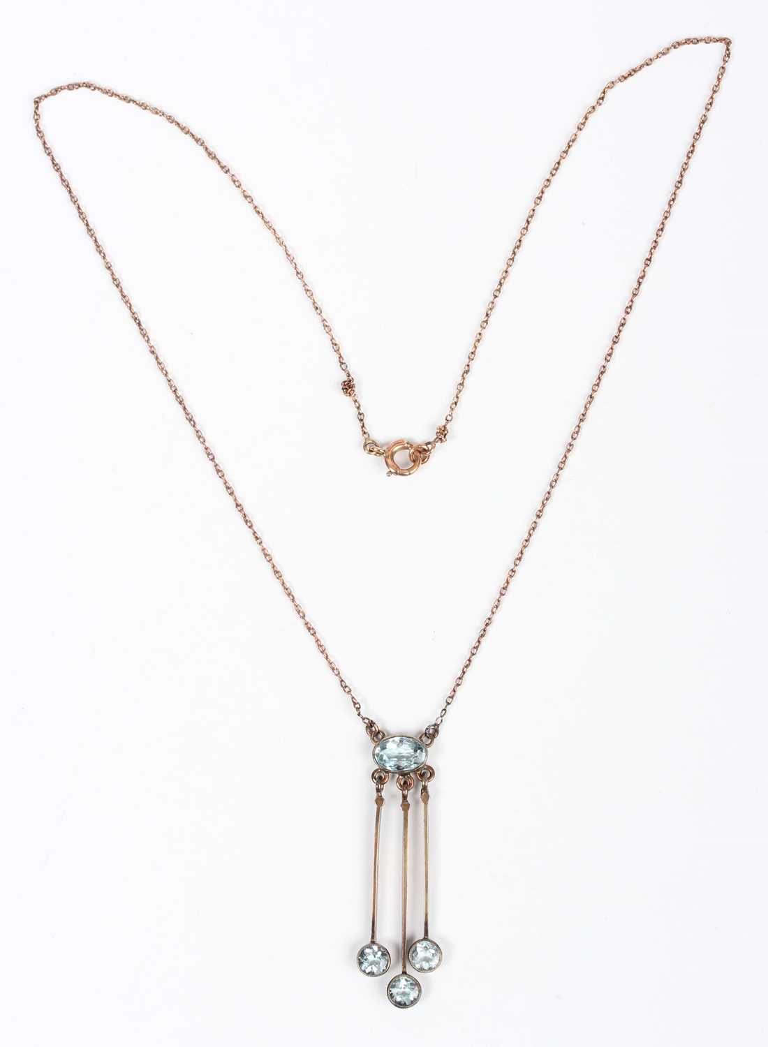 A gold and aquamarine pendant necklace, circa 1910, collet set with the principal oval cut - Image 2 of 3