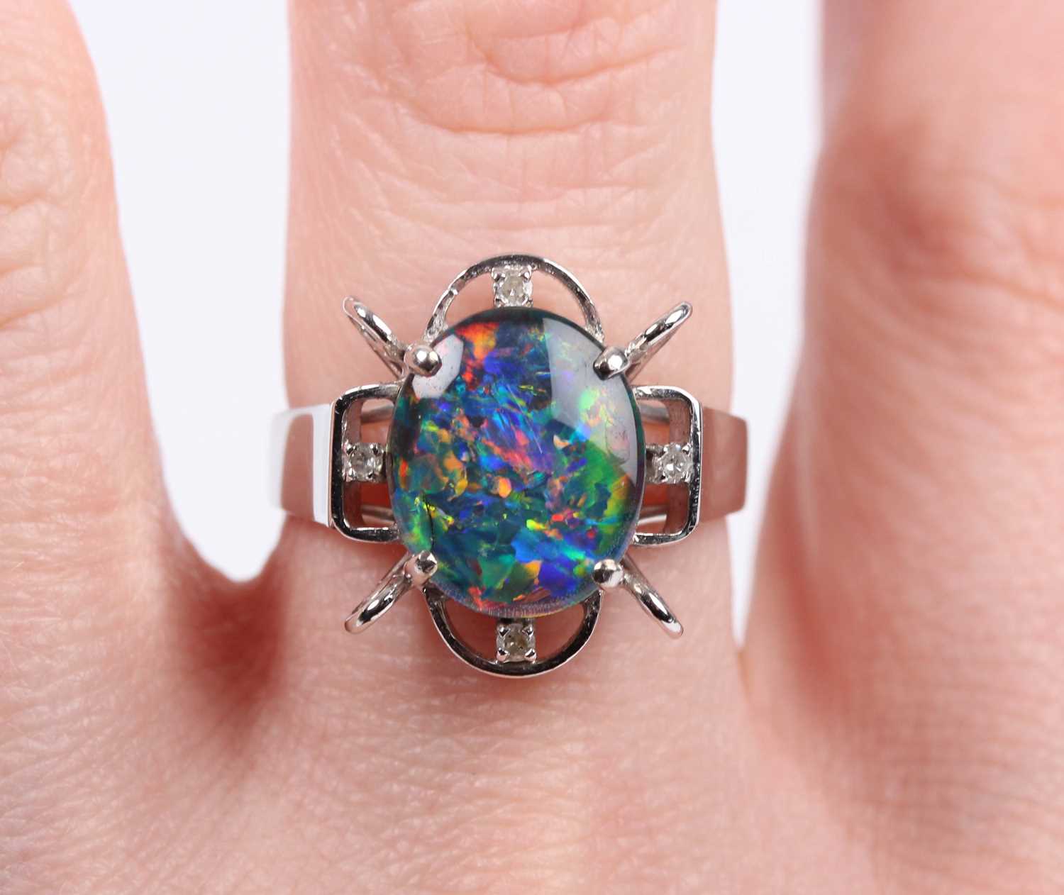 A white gold, opal triplet and diamond ring, claw set with the oval opal triplet in an openwork - Image 5 of 5