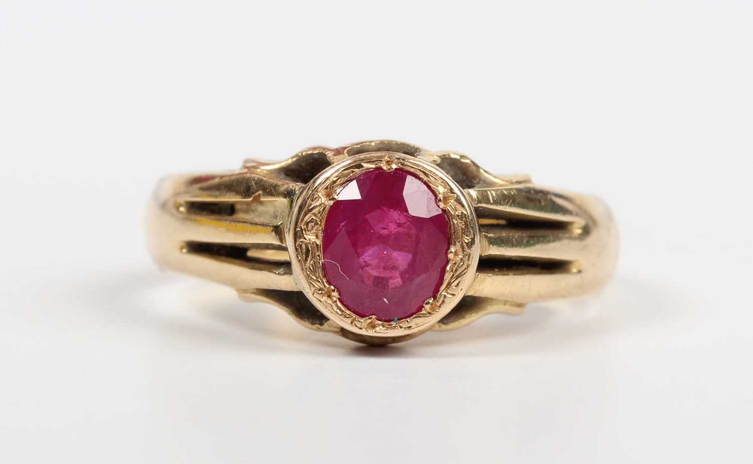 A gold ring, mounted with an oval cut treated ruby, detailed ‘18ct’, weight 6.4g, ruby weight approx - Image 2 of 5