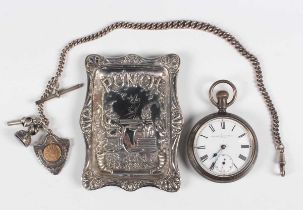 A late Victorian silver shaped rectangular 'Punch' pin dish, embossed with a scene of Mr Punch