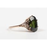 A gold ring, claw set with an oval cut green zircon, unmarked, weight 2.8g, zircon weight approx 5.