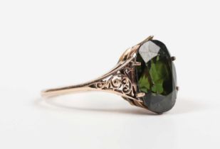 A gold ring, claw set with an oval cut green zircon, unmarked, weight 2.8g, zircon weight approx 5.