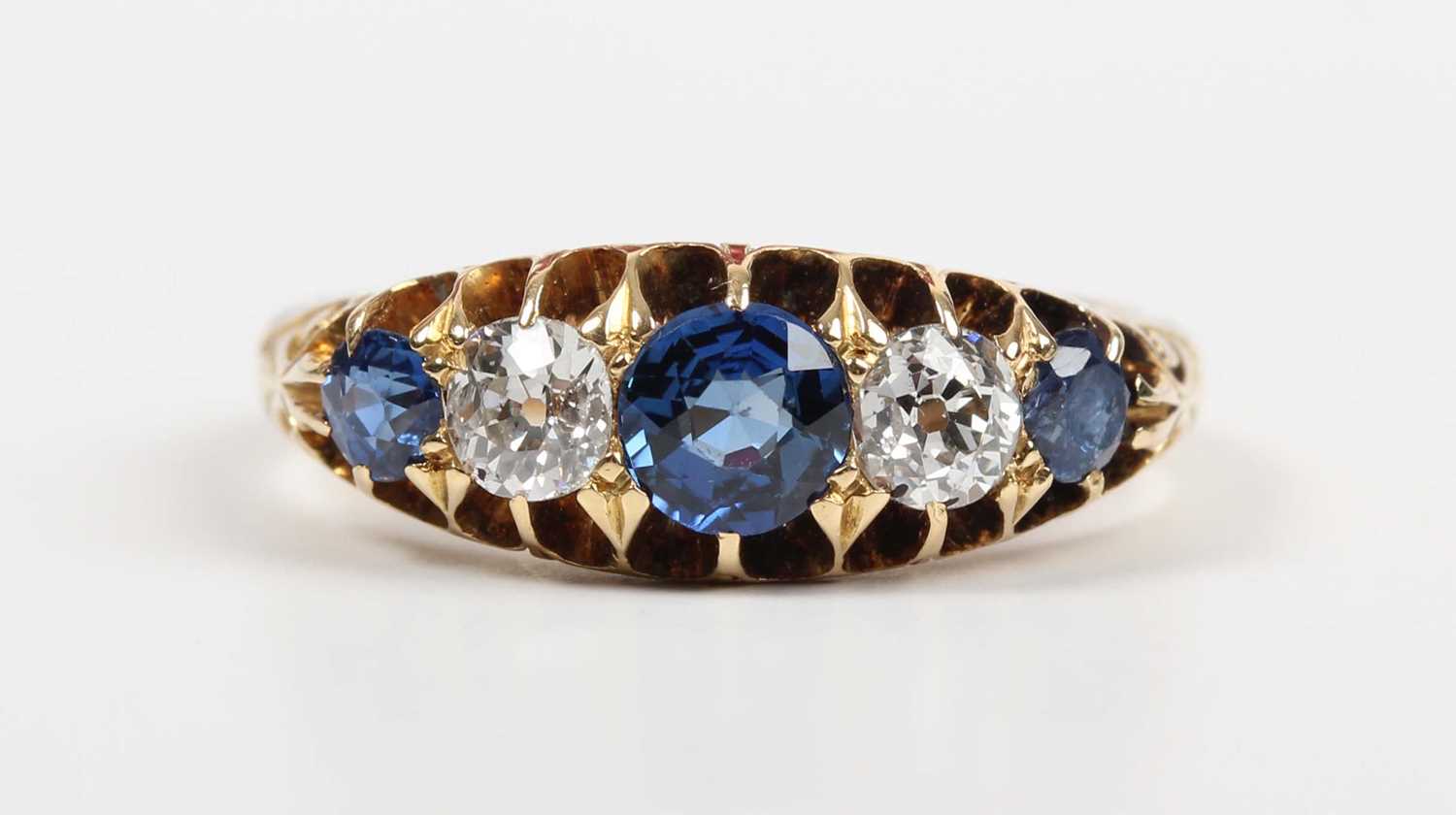 A gold, sapphire and diamond ring, mounted with three sapphires alternating with two old cut - Image 2 of 5