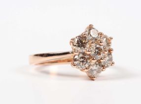 A rose gold and diamond cluster ring, mounted with seven circular cut diamonds, weight 5.8g, total