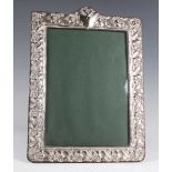 An Elizabeth II silver mounted rectangular photograph frame with arched top, embossed with