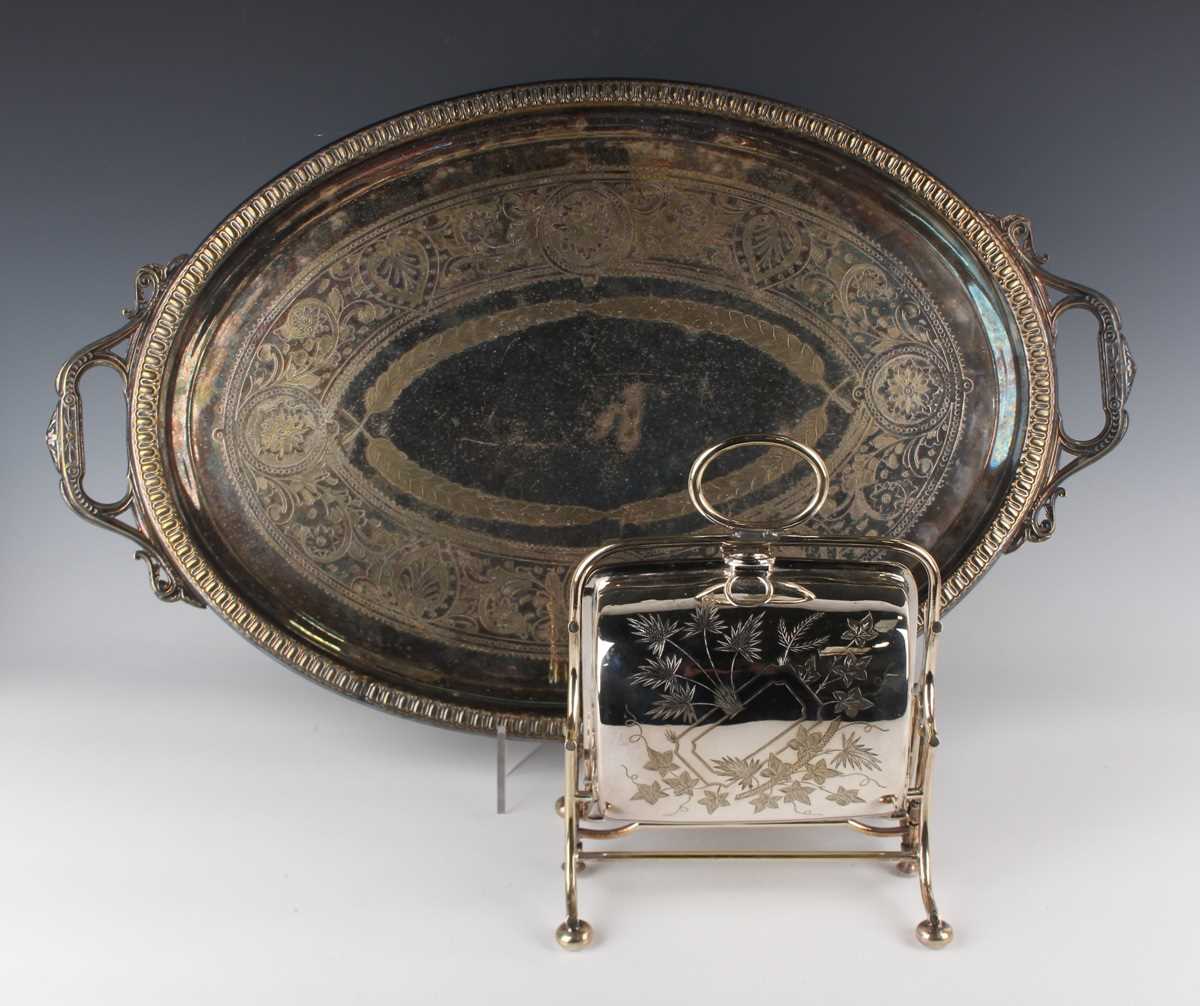 A plated biscuiteer with central handle, engraved with foliate decoration, on bun feet, height 26cm,