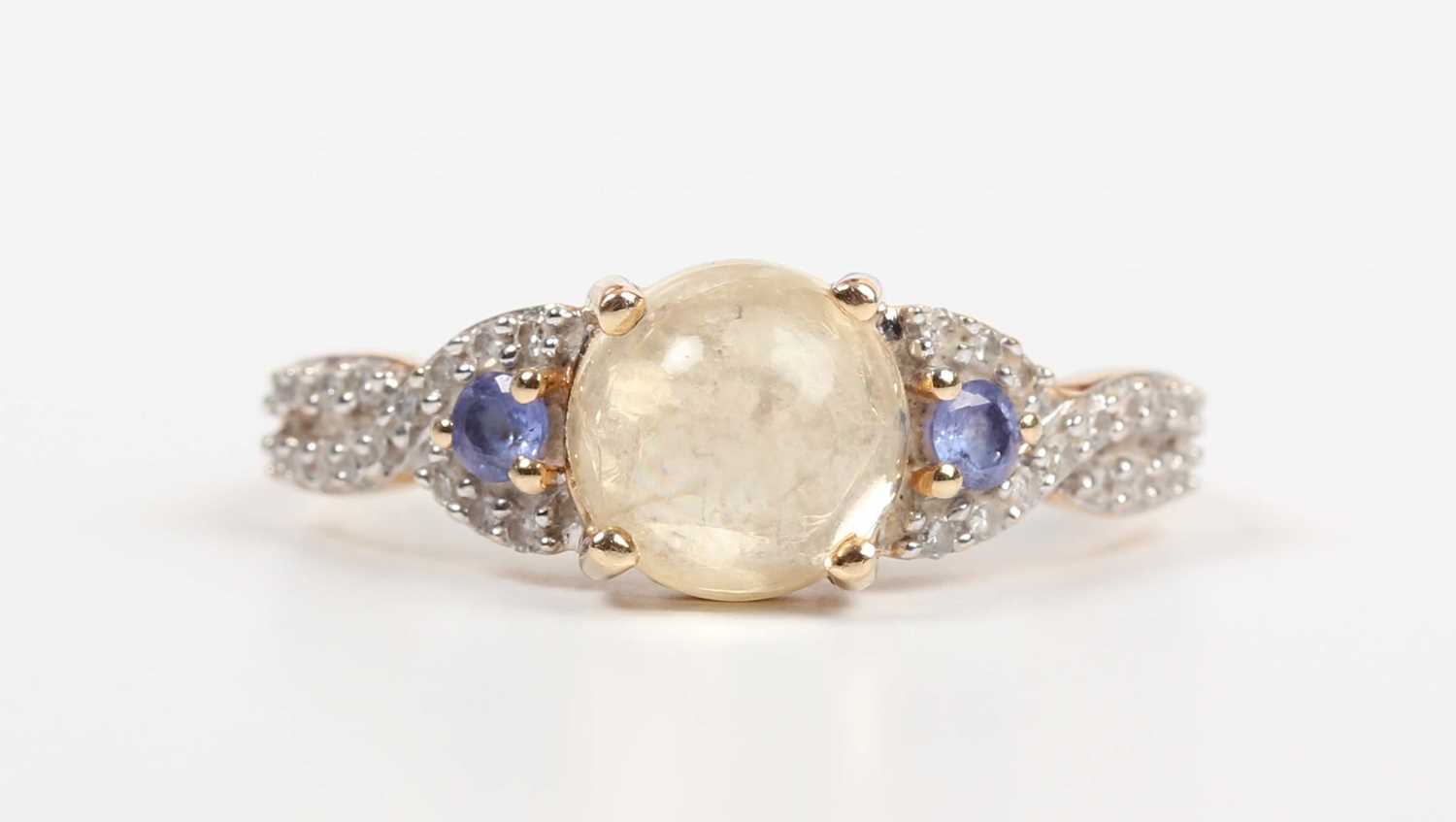 A 14ct gold ring, mounted with a central cabochon pale yellow opal between diamond and pale blue gem - Image 2 of 5