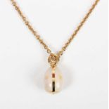 A modern Fabergé gold and semitranslucent pink enamelled egg pendant, decorated with gold stars,