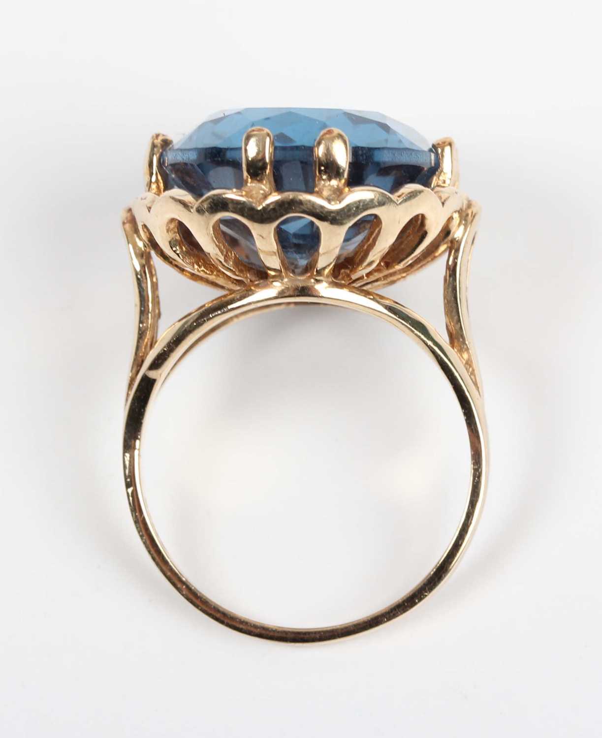 A 9ct gold ring, claw set with a large oval cut synthetic blue spinel, London 2009, weight 9g, - Image 4 of 5