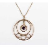 A gold, amethyst and seed pearl pendant in an openwork design, unmarked, weight 2.3g, length 3cm,