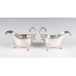 A pair of George III silver sauceboats, each with gadrooned rim and foliate capped scroll handle, on