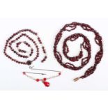 A multiple strand necklace of faceted garnet beads, with larger garnet beads mounted at intervals,