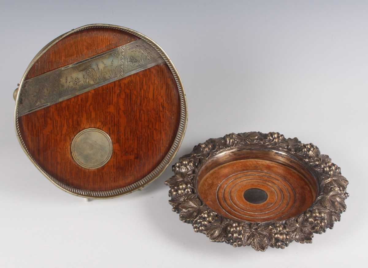 A late Victorian plate mounted circular tray, the oak base inset with a circular plaque beneath an