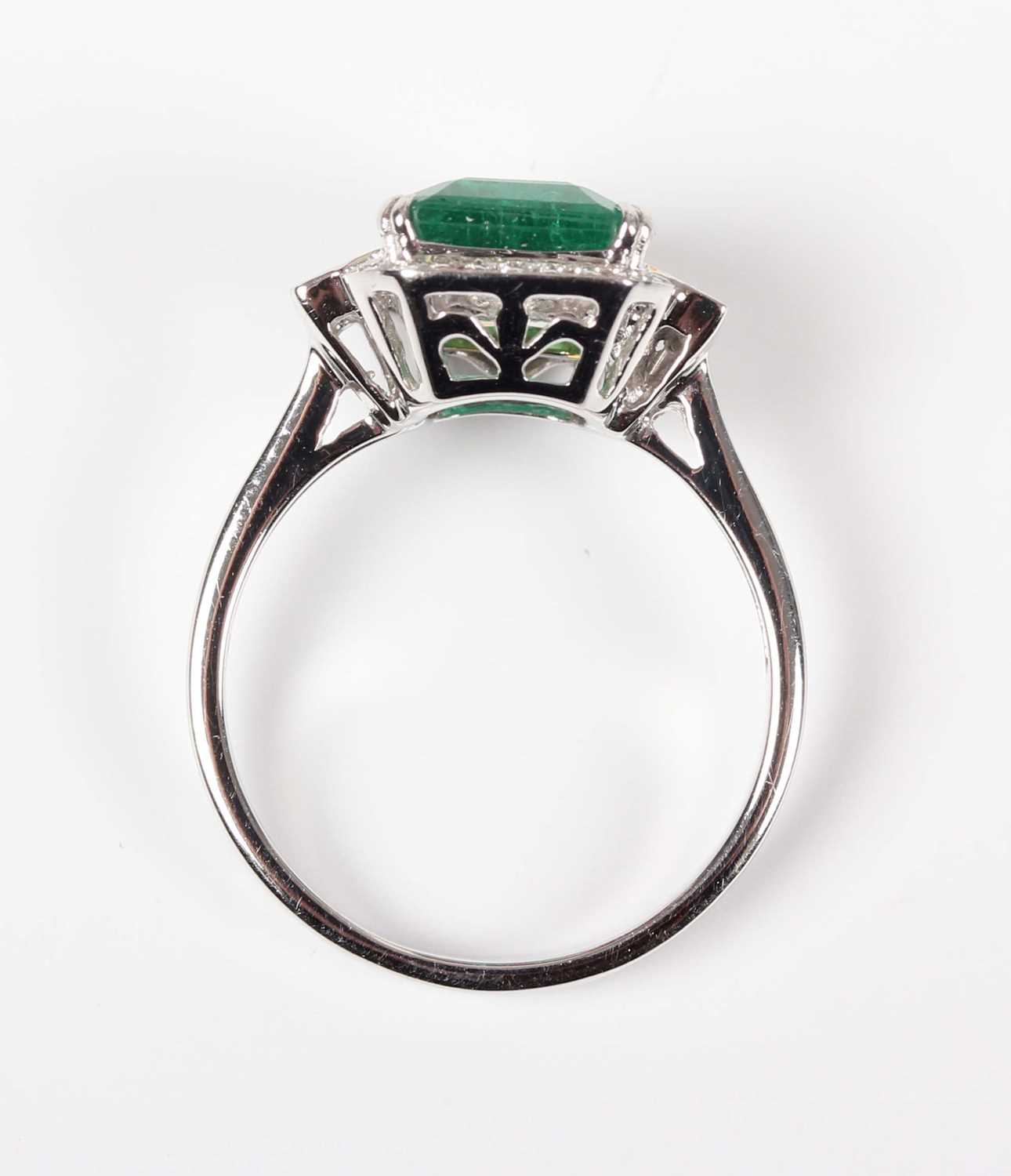 A white gold, treated emerald and diamond ring, claw set with a cut cornered rectangular step cut - Image 4 of 6