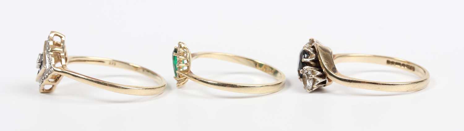 A 9ct gold ring, mounted with a central diamond within a surround of eight square cut sapphires, the - Image 3 of 4