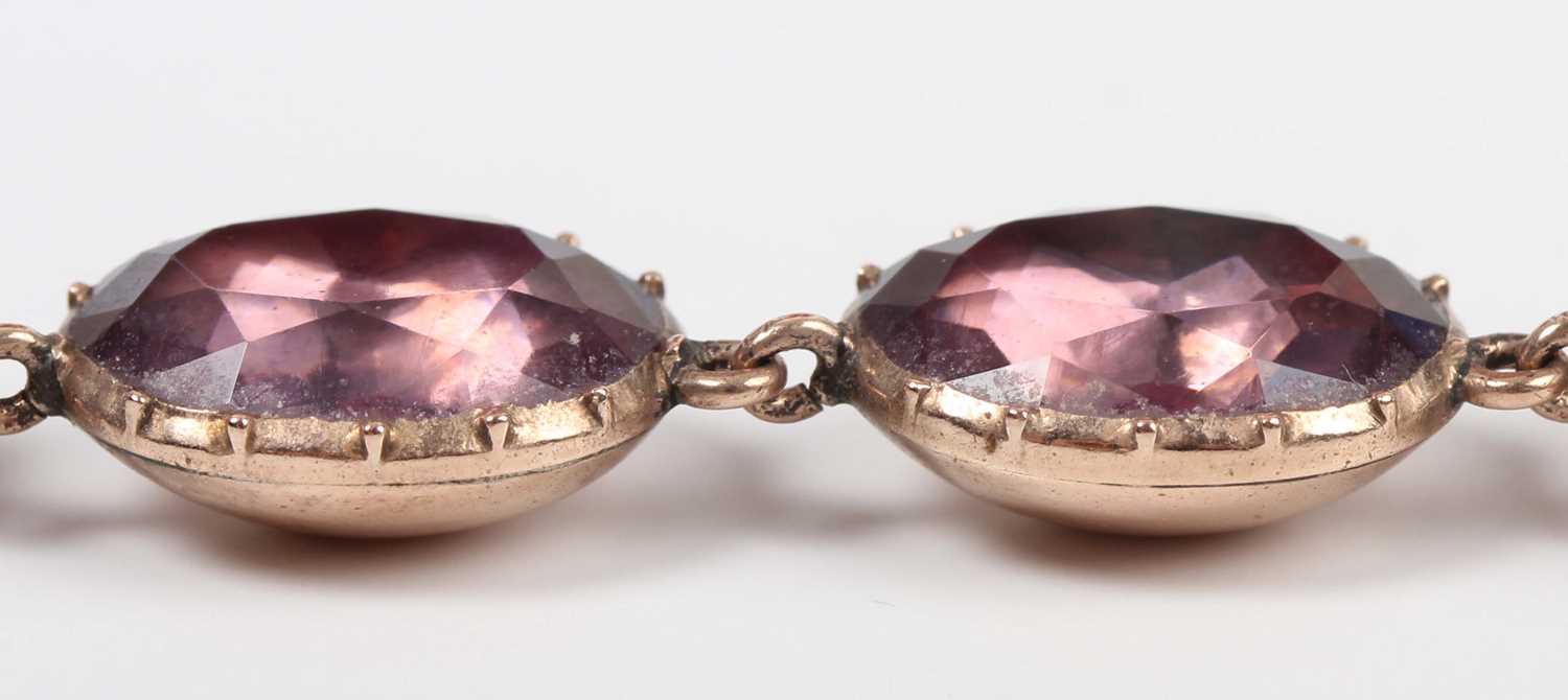 A Georgian gold and foil-backed mauve paste necklace, mounted with a row of graduated oval cut mauve - Image 4 of 4
