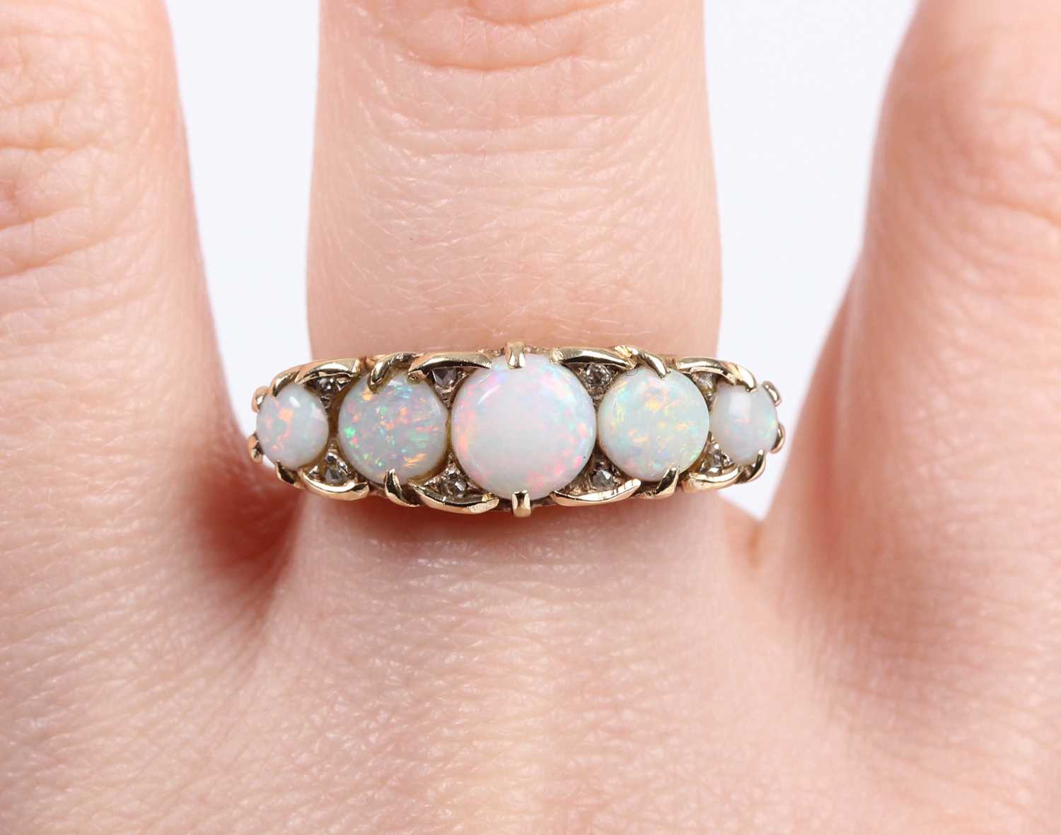 A gold, opal and diamond ring, mounted with a row of five graduated circular opals with four pairs - Image 5 of 5