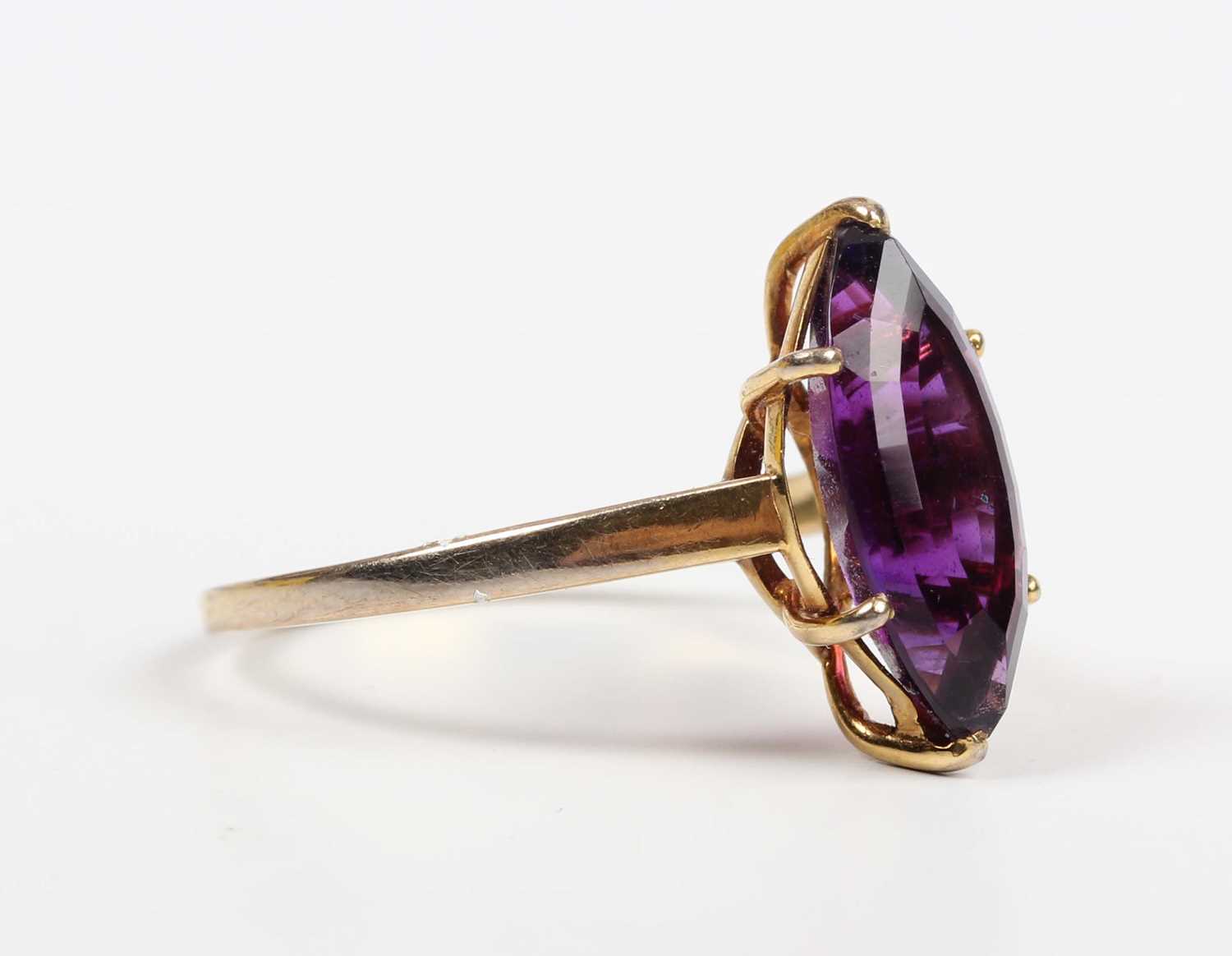 An 18ct gold ring, claw set with a marquise shaped amethyst, London 1985, weight 3.8g, ring size