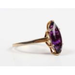 An 18ct gold ring, claw set with a marquise shaped amethyst, London 1985, weight 3.8g, ring size