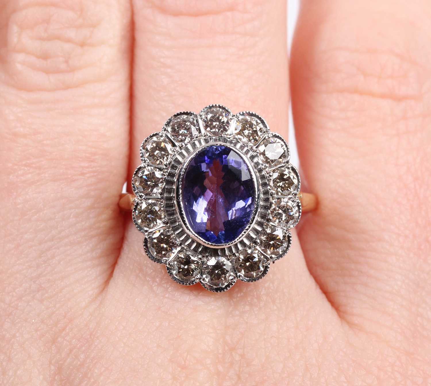 A gold, tanzanite and diamond oval cluster ring, collet set with the oval cut tanzanite within a - Image 5 of 5
