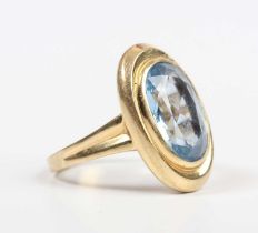 A gold ring, collet set with a large oval cut synthetic blue spinel, detailed ‘750’, weight 6.3g,