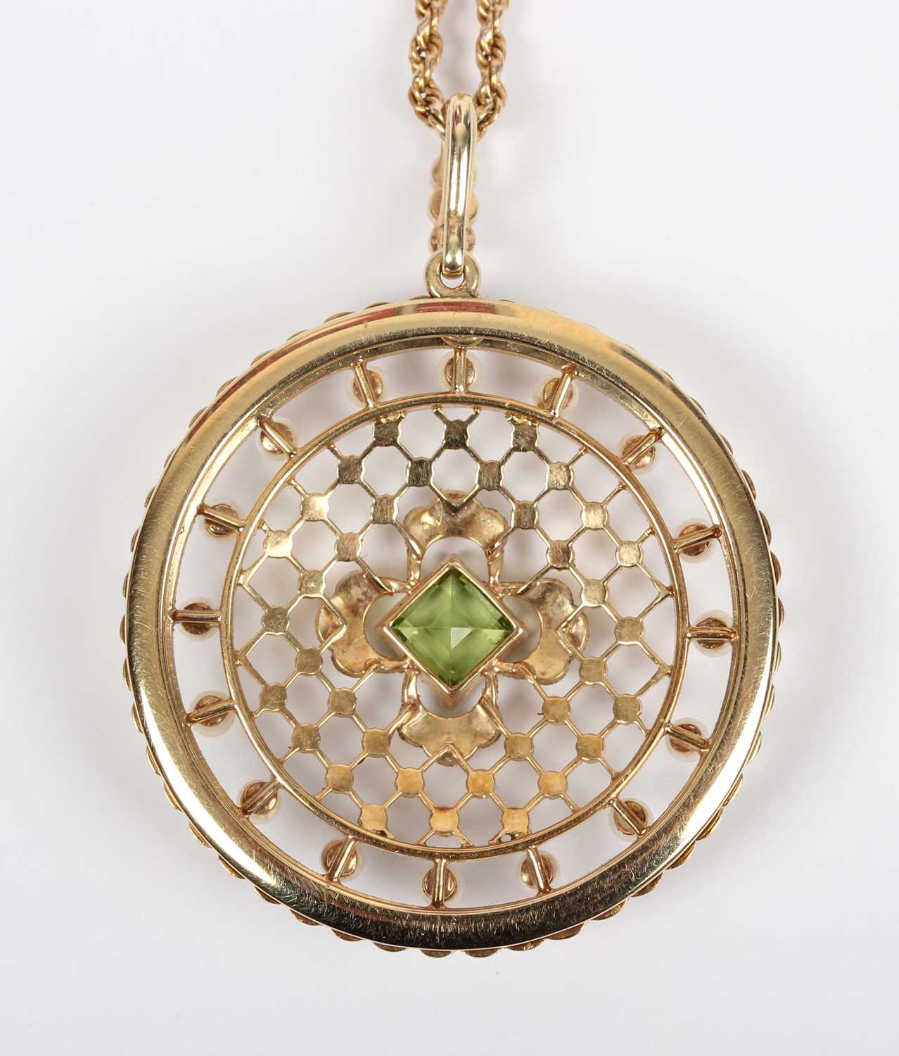 An Edwardian gold, peridot and seed pearl circular pendant of openwork design, mounted with the - Image 3 of 5